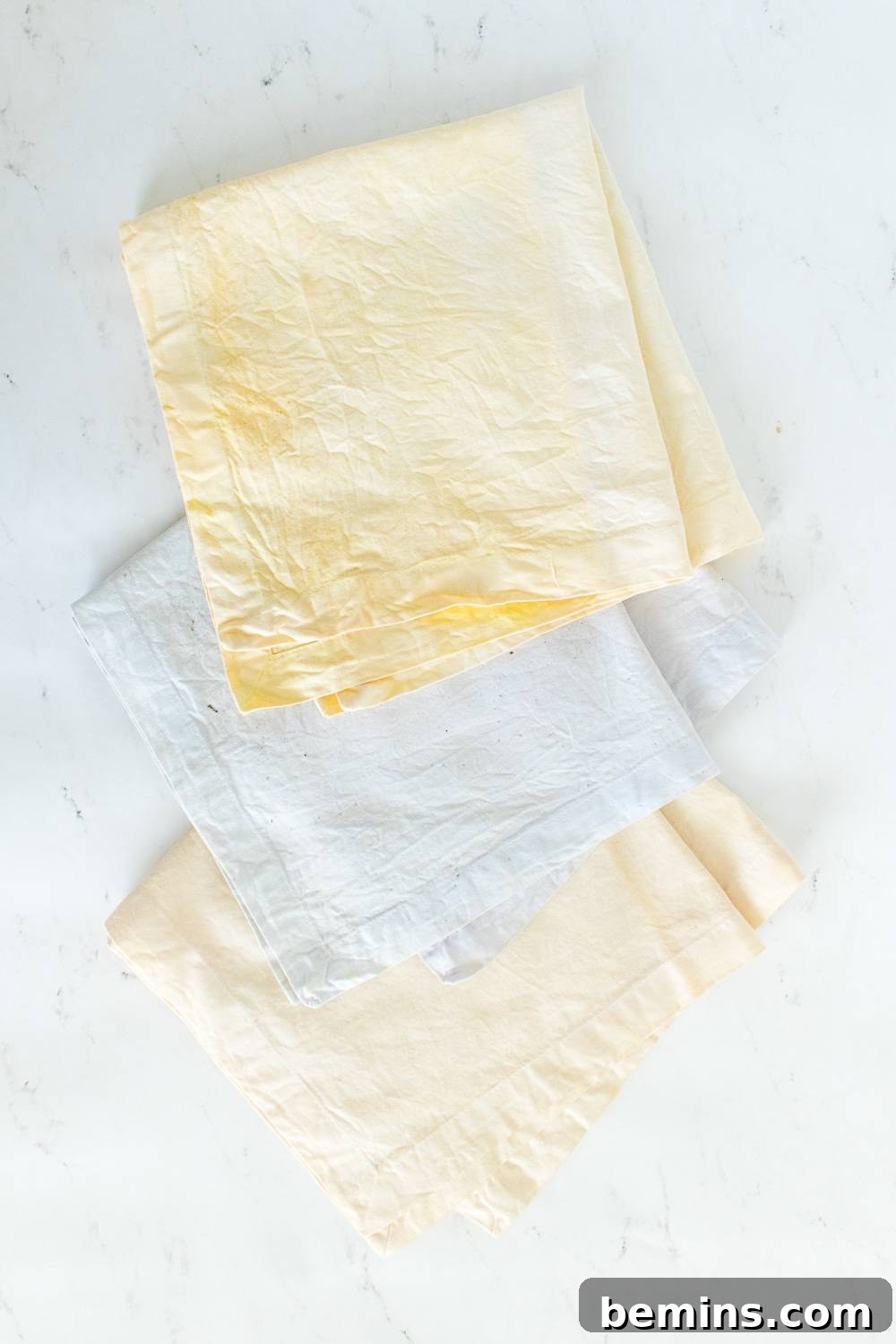 Small, naturally dyed pastel napkins arranged elegantly on a table.