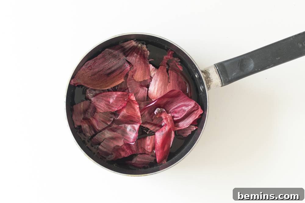 A pot filled with water and a generous amount of red onion skins, ready to be simmered for a natural dye bath.