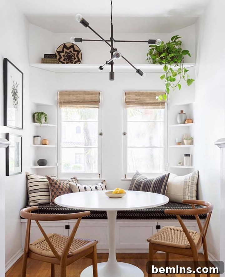 Cozy bohemian living room with neutral tones, layered textiles, and lush green plants, showcasing Katie Hodges Design's aesthetic.