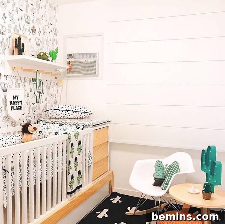 Charming bohemian nursery with black and white elements, a crib, and subtle green plant accents by Audrey Crisp.