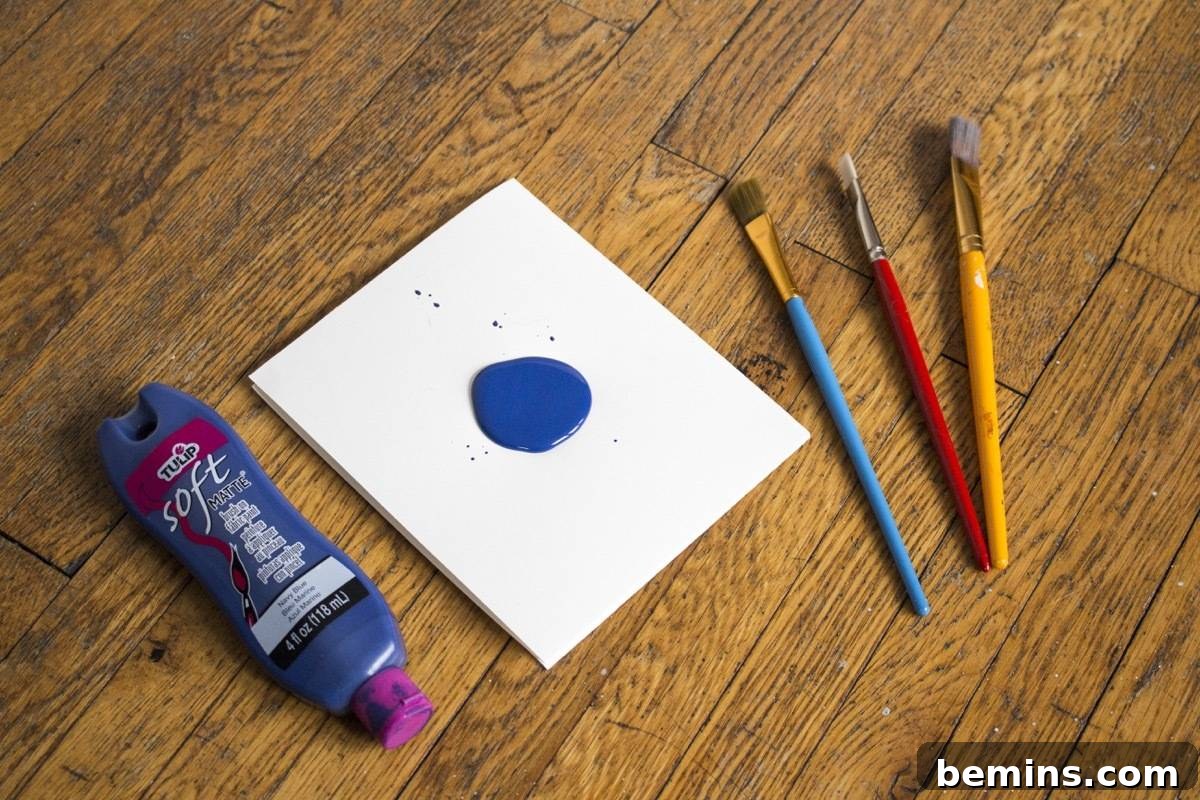 Preparing the workspace for painting an umbrella: paint, brushes, and palette