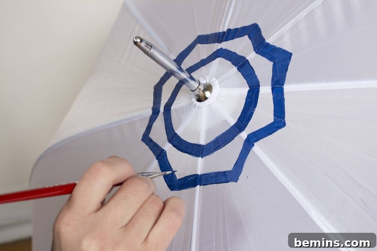 Painting an umbrella with fabric paint: applying the first layer of color