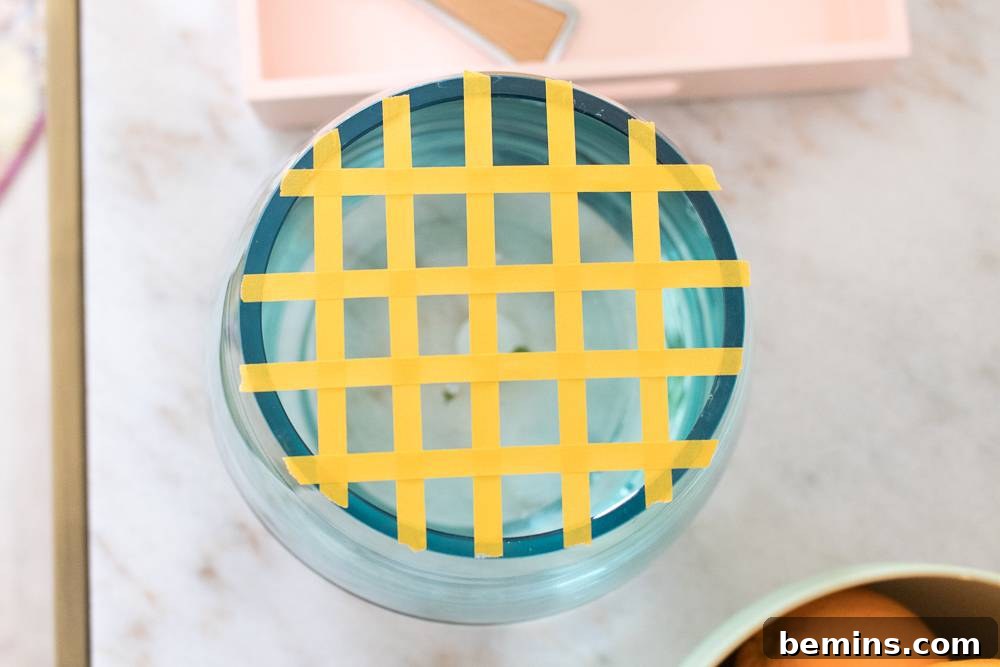 Turning Everyday Grocery Store Flowers into Stunning Floral Art 4 A vase with a yellow tape grid on top.