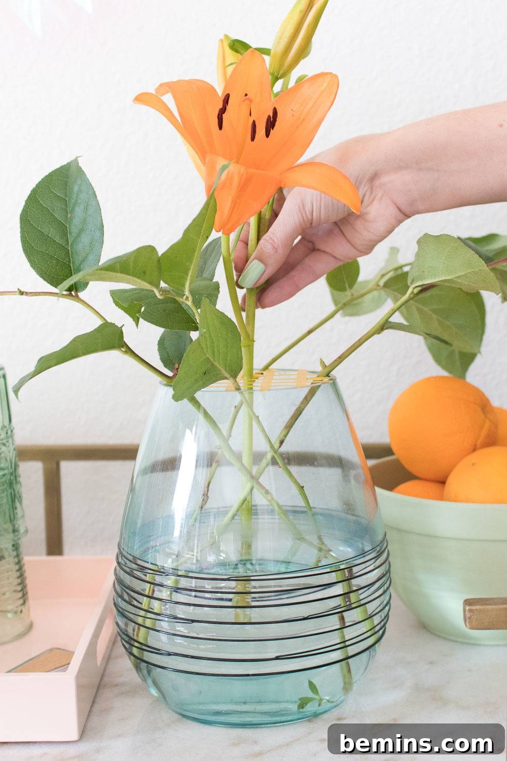 Turning Everyday Grocery Store Flowers into Stunning Floral Art 6 Placing the centerpiece lilies in the vase.