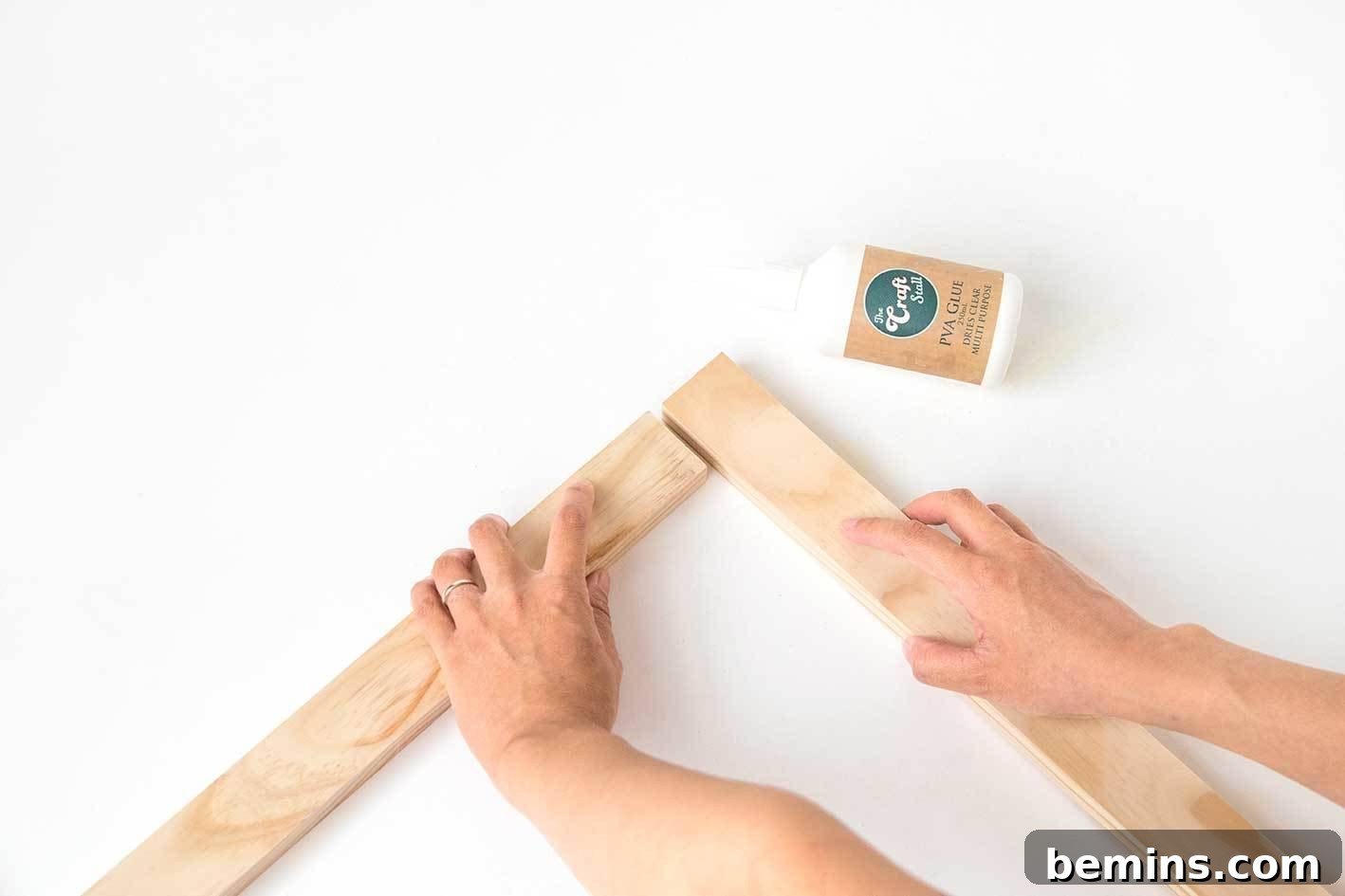 Gluing the wood pieces together to form the frame.
