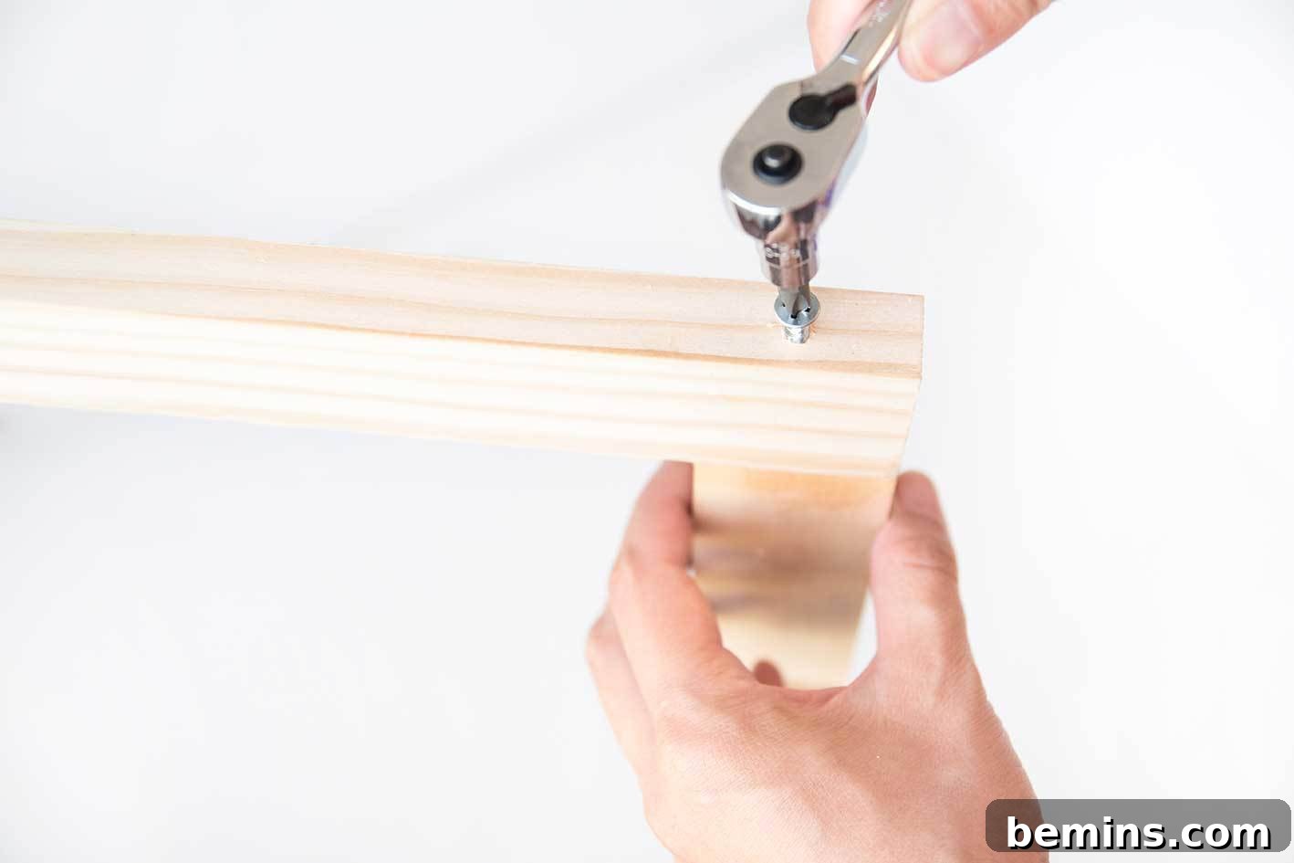 Securing the frame with screws for added stability.