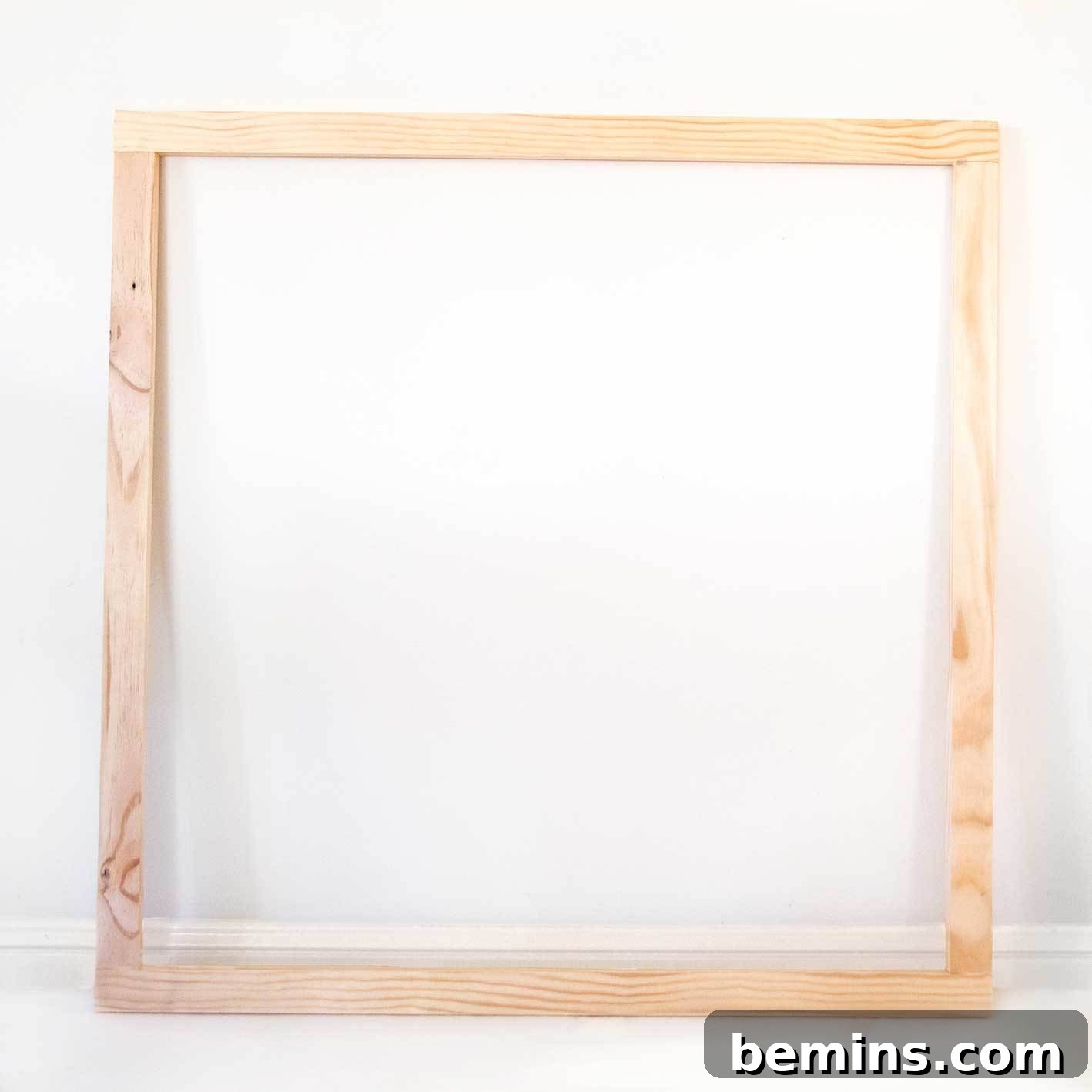 Stapling the fabric onto the wooden frame.
