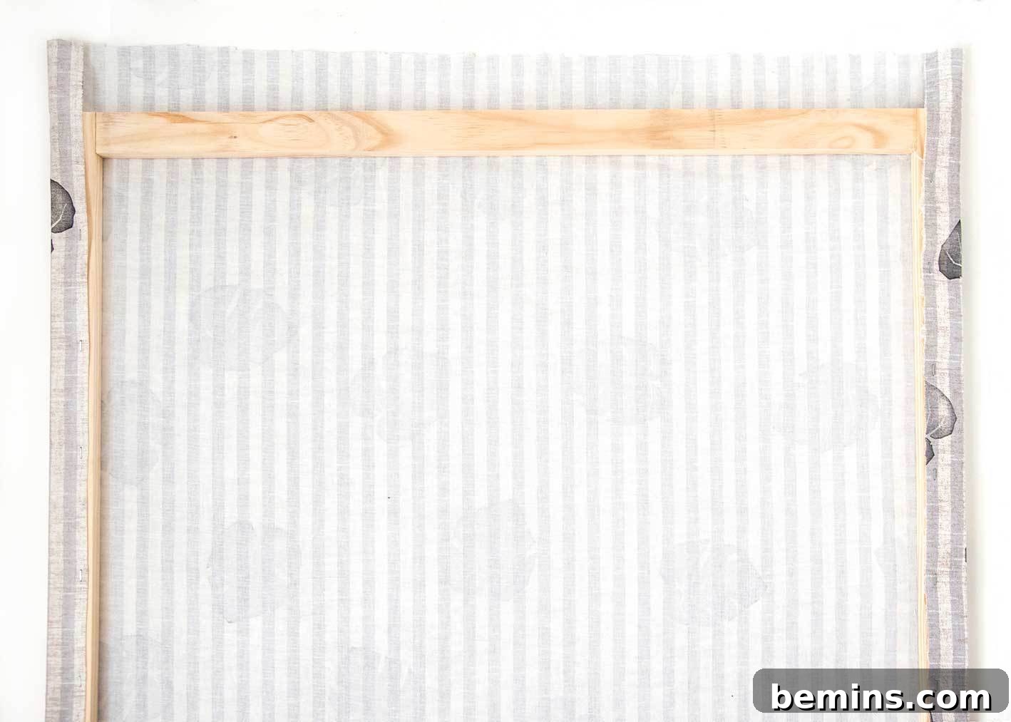 Adding the hanging cord to the back of the fabric art.