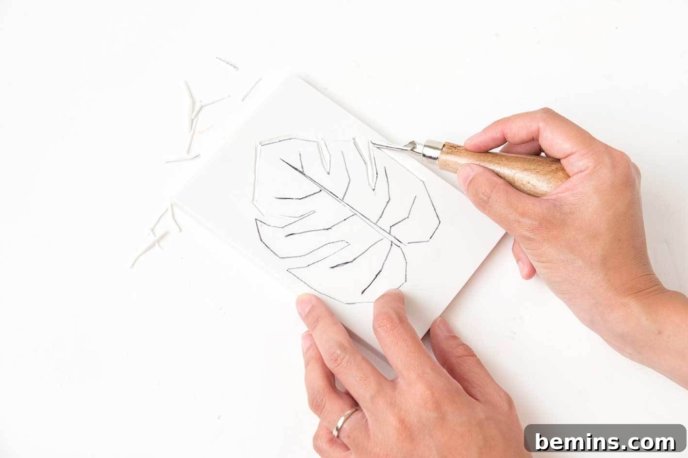 Carving the lino block to create the leaf stamp.