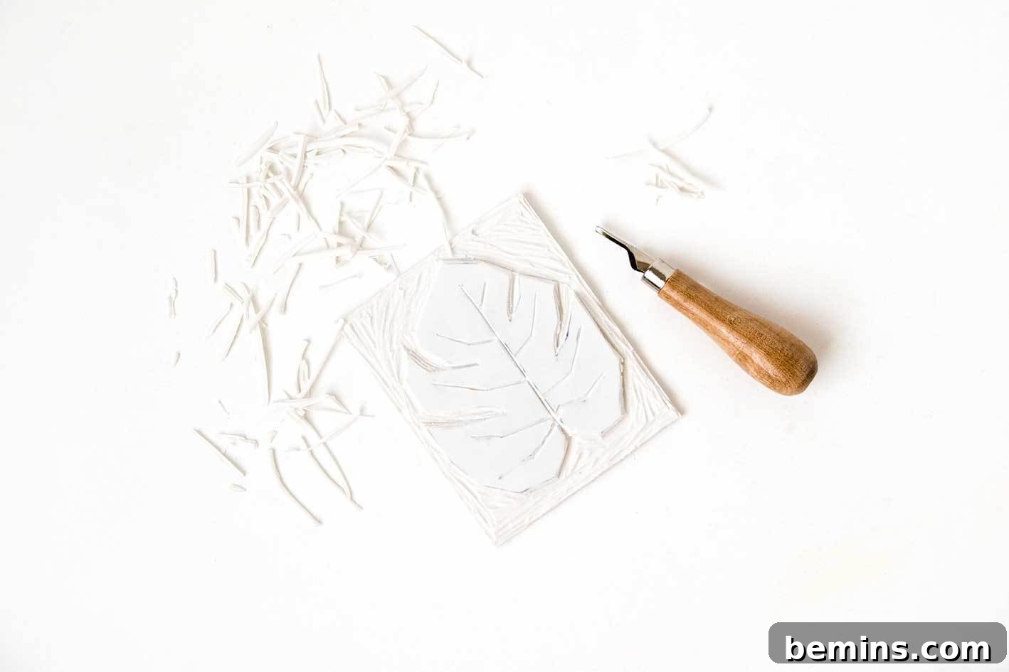Inking the carved lino stamp with fabric ink.