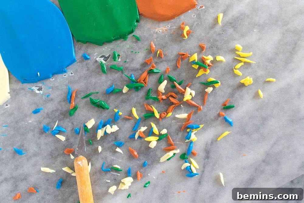 Small pieces of clay sitting on the ground next to each other next to a wooden stick.