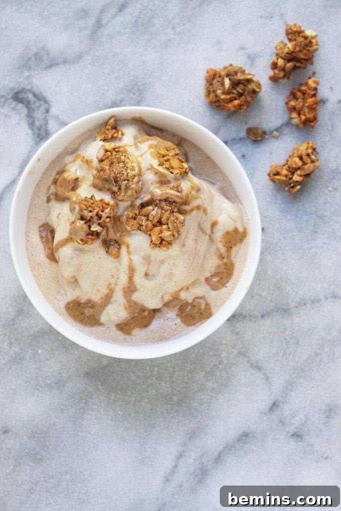 A banana nut butter smoothie bowl with granola