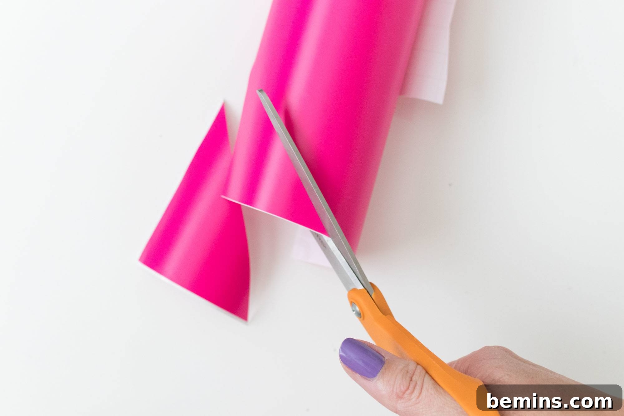 Cutting Pink Vinyl Sheet with Scissors