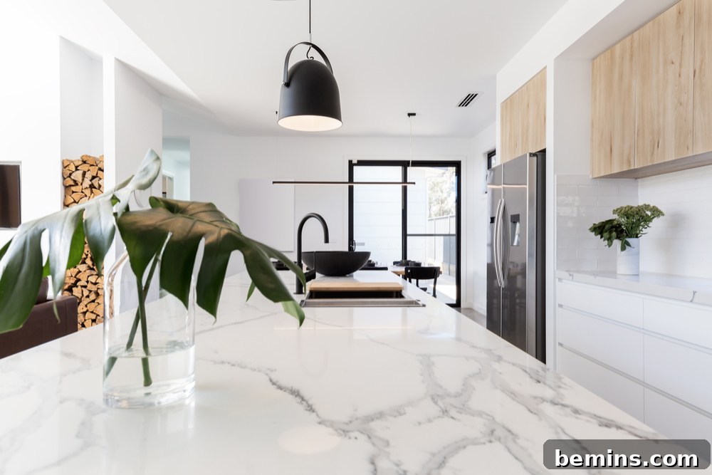 Elegant kitchen with marble island and white countertop. Wooden cabinets provide ample storage.