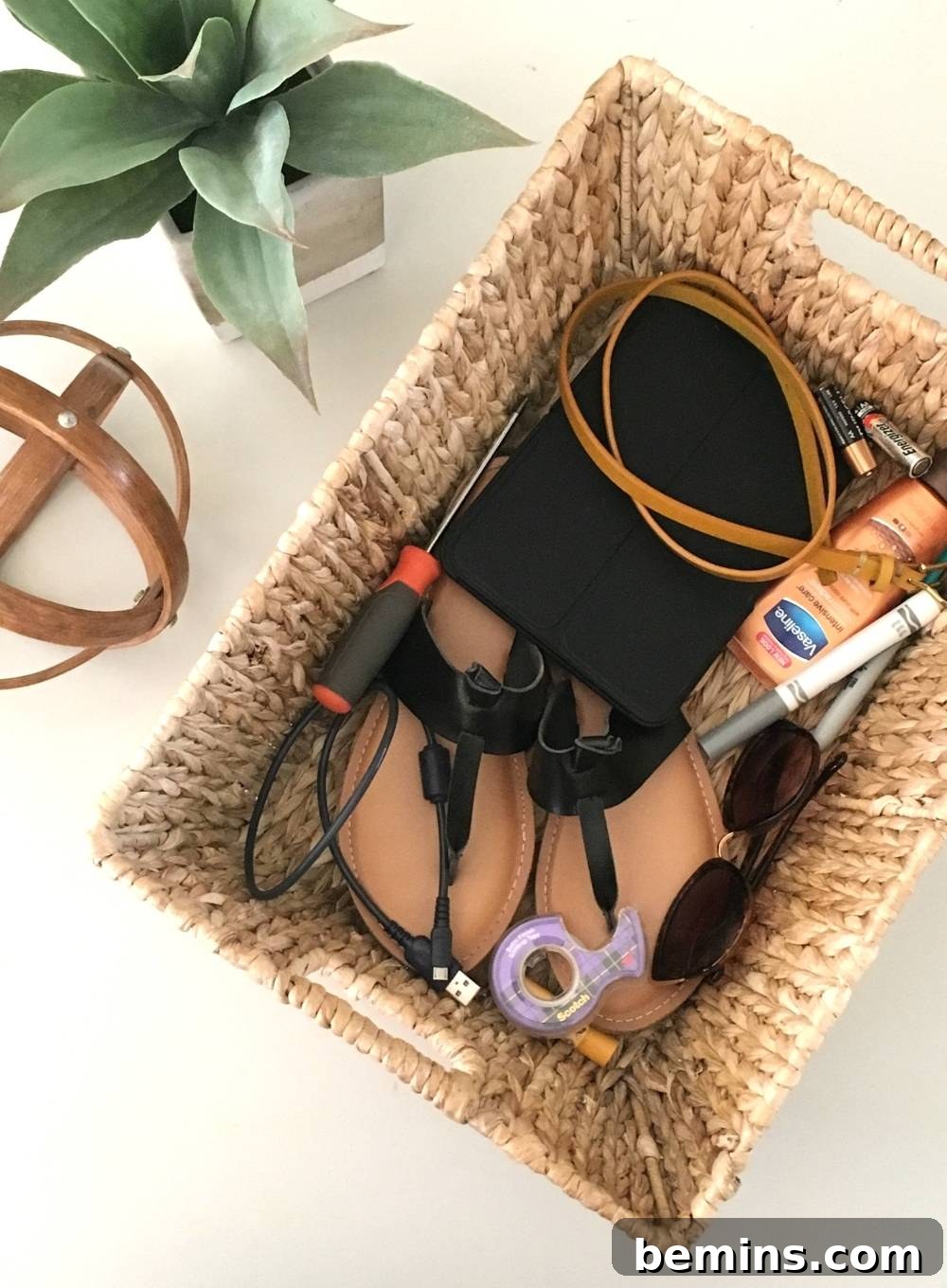 A wicker basket filled with various household items, demonstrating the clutter basket concept.