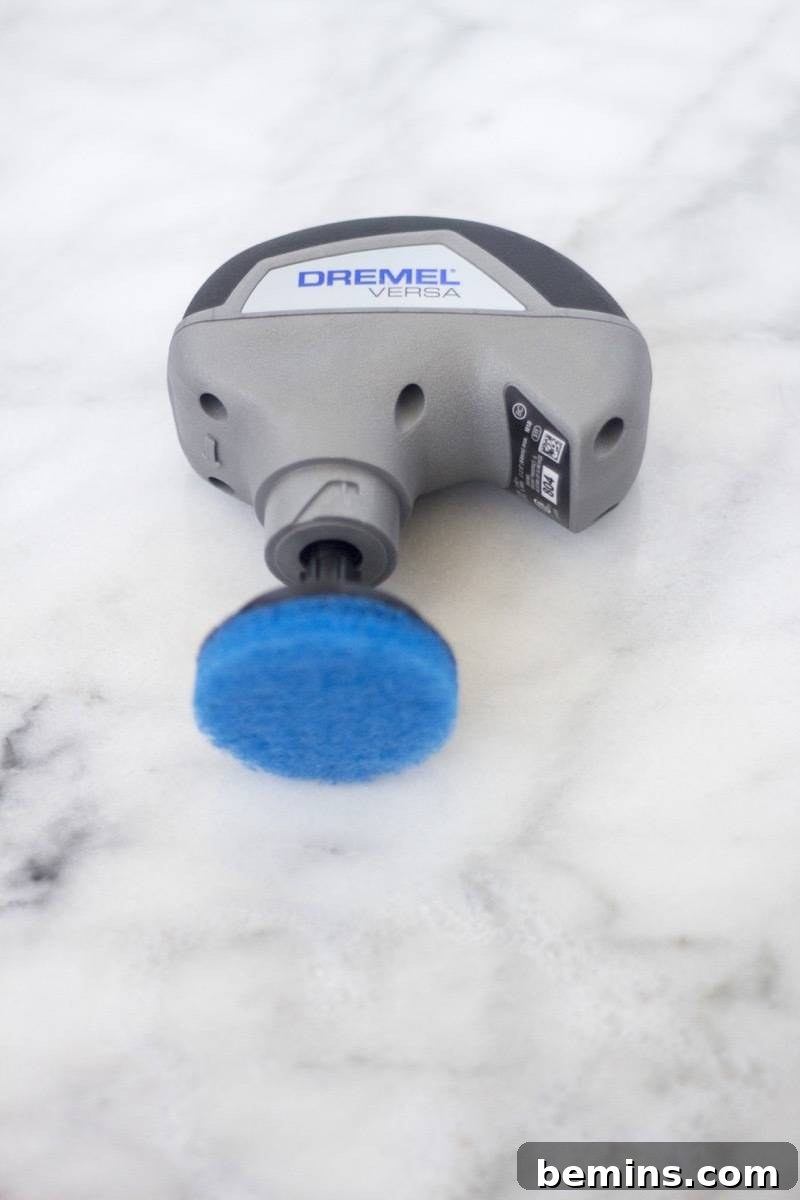 This Gadget Will Revolutionize Your Home Cleaning 8 Close up of the end of the Dremel Versa showing the blue power button