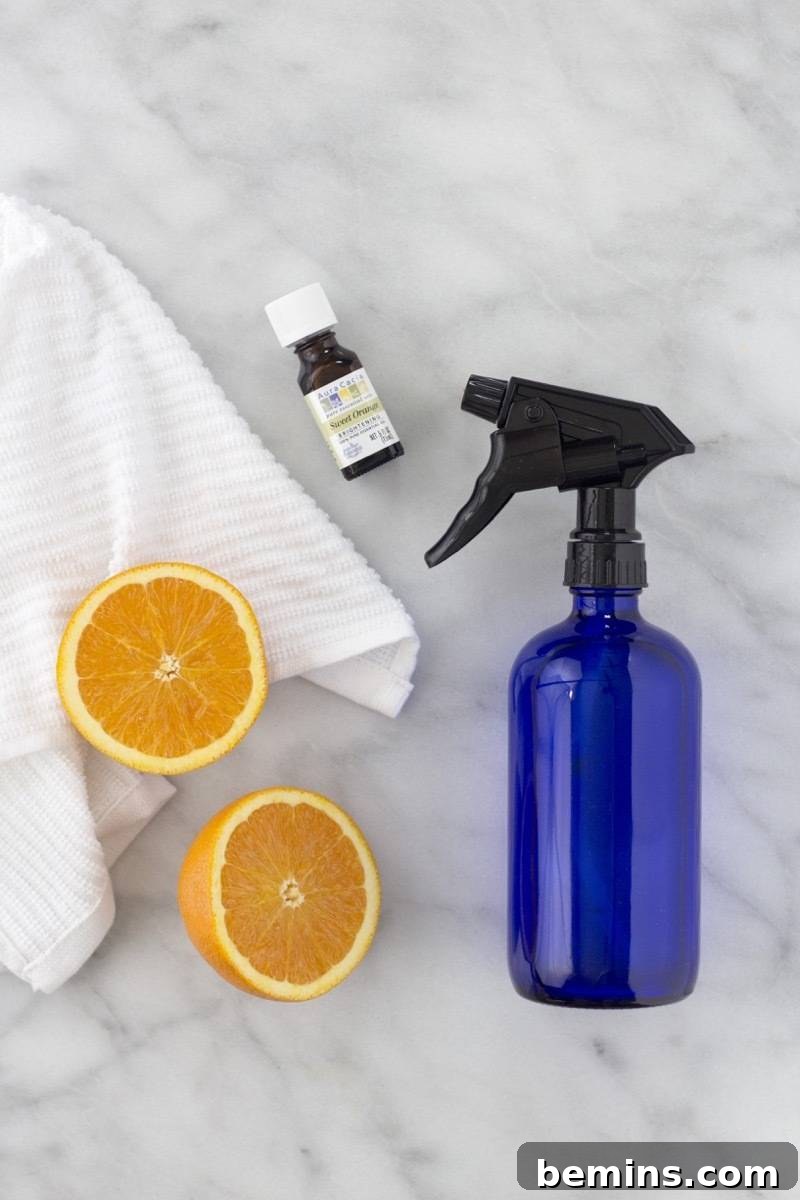 Ingredients for homemade window cleaner: water, rubbing alcohol, white vinegar, and orange essential oil