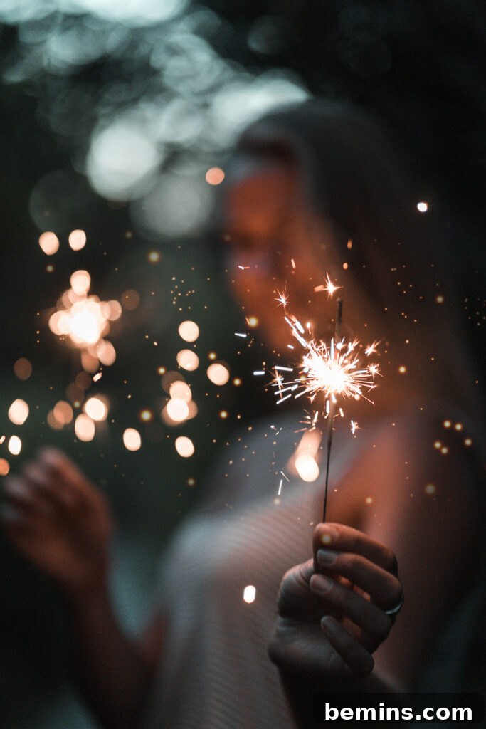 Capturing Magical Sparkler Moments with Your Phone 2 A hand holding a lit sparkler, emitting bright light