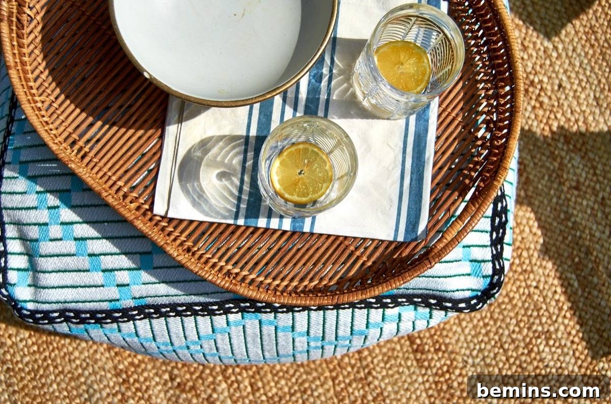 Summer-Ready Patio: A Fast & Fun Refresh 16 Two mostly empty glasses with orange slices in the bottom sit on a tray on a patio table.