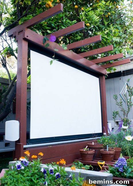 Permanent backyard movie screen surrounded by flowers
