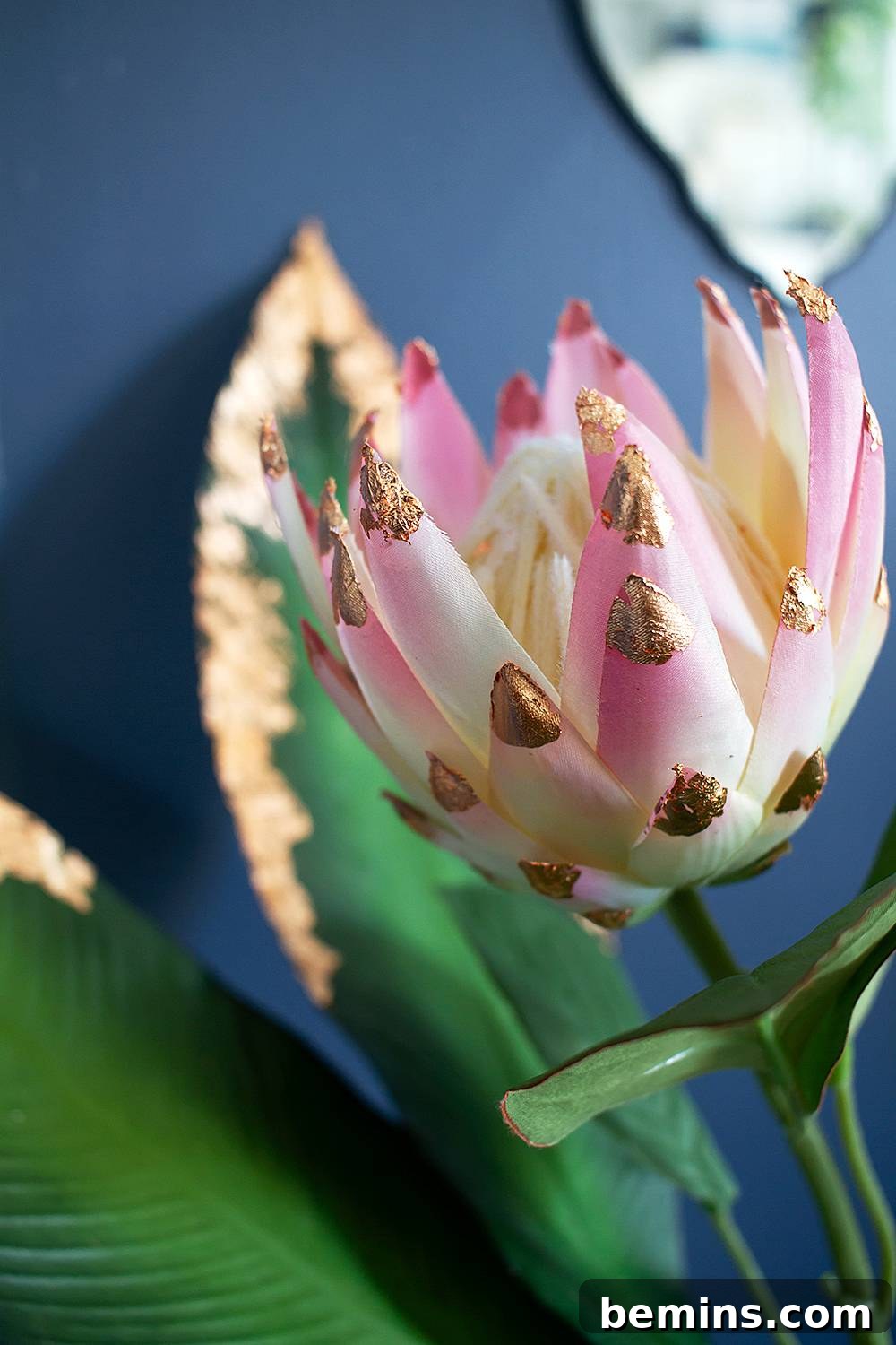 Close-up of copper leaf detailing on fake flower petals.