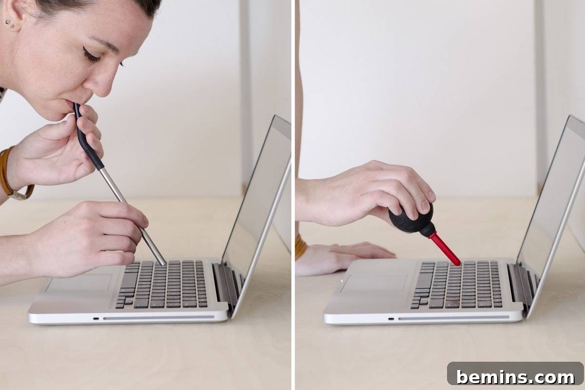 Removing crumbs from laptop keyboard using a straw