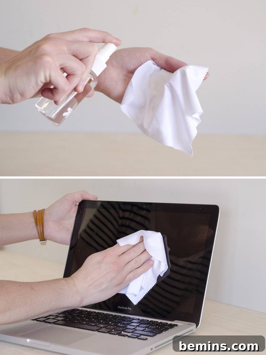 Cleaning laptop screen with a microfiber cloth