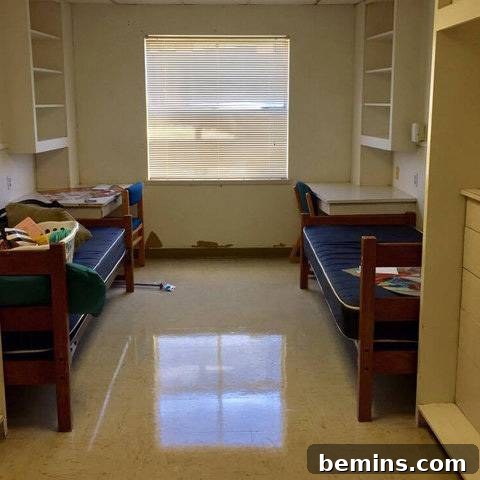 Before: Two twin beds with dark blue mattresses sit on either side of a dorm room.