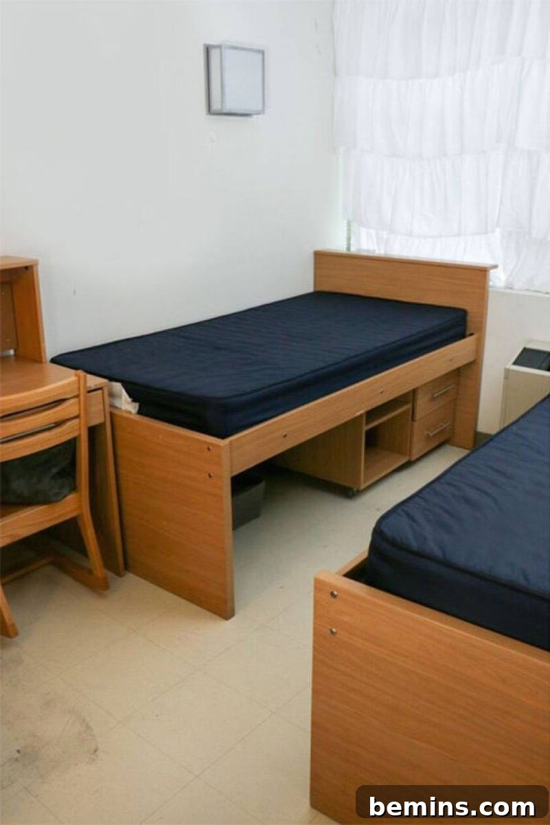 Before: Two twin beds with wooden frames set up in a small room.