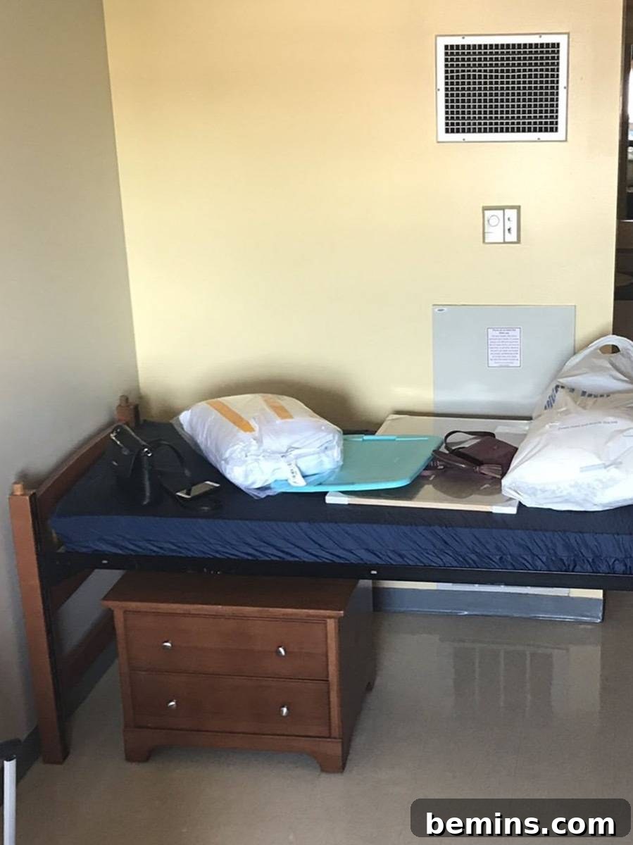 Before: A small dorm bed with various items on top.