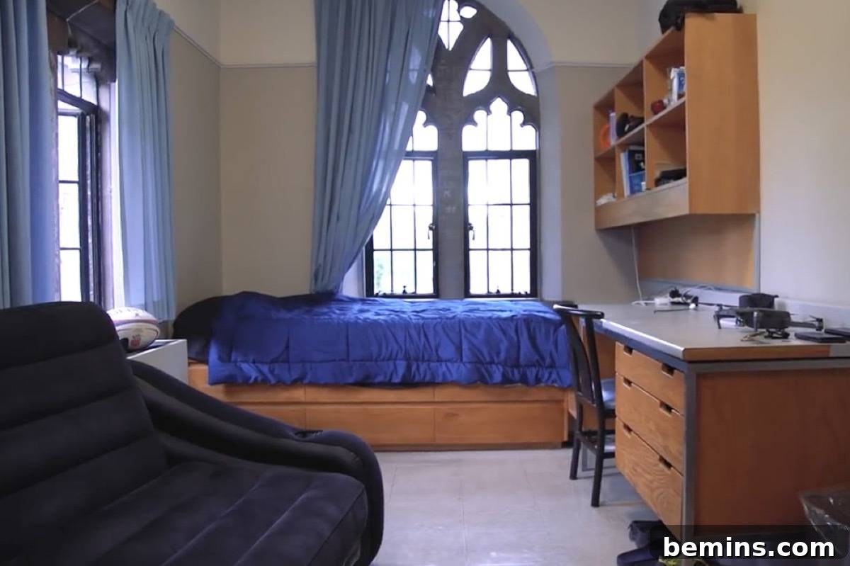 Before: Room having a wooden table, chair and a bed having blue bedsheet.