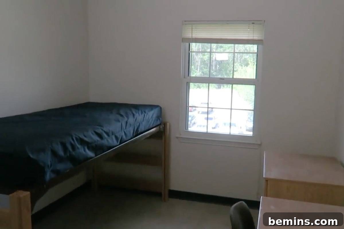 Before: Sparsely furnished dorm room with a window on the wall between a single bed and desk.