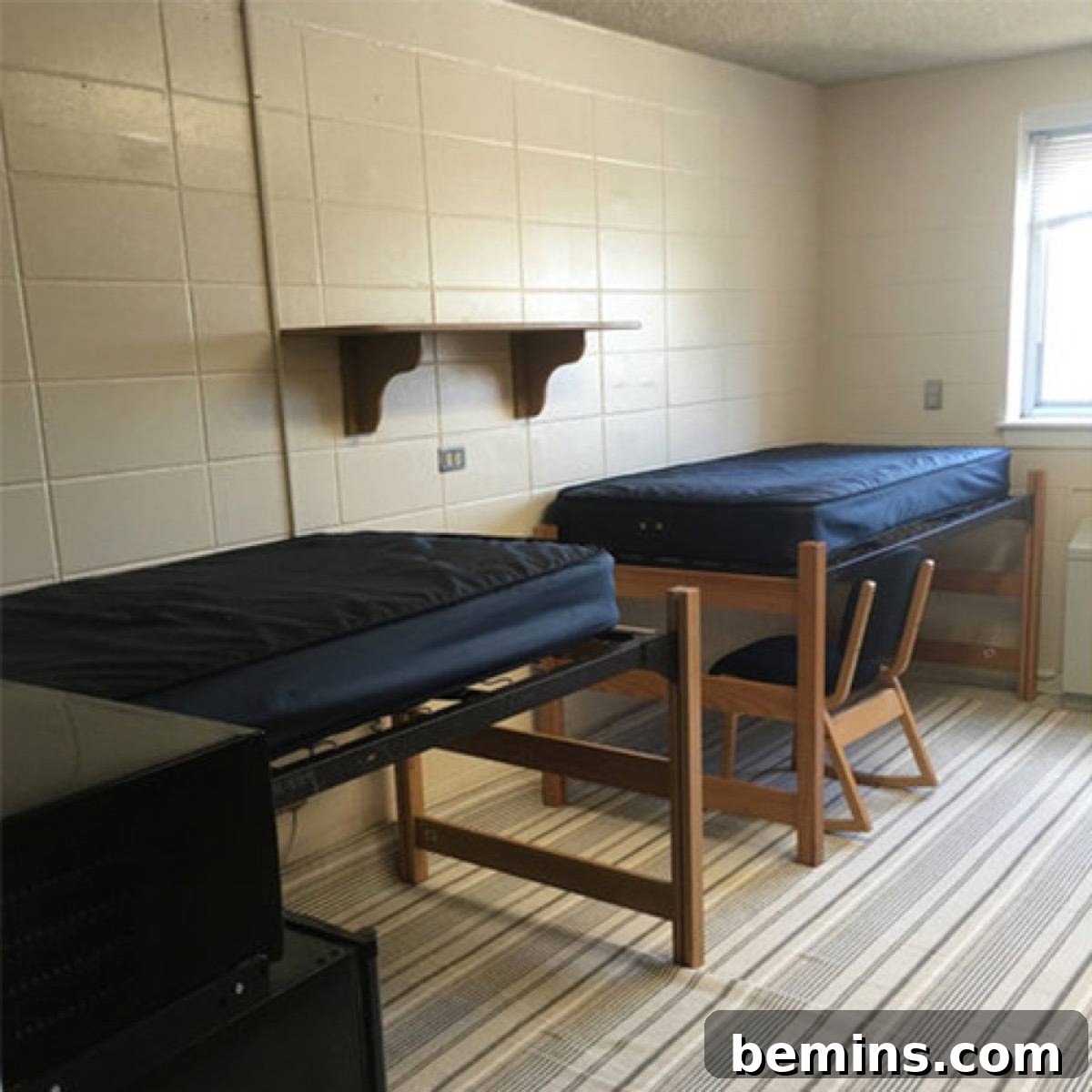 Before: Two wooden beds line near the wall of a room with a wooden chair under it