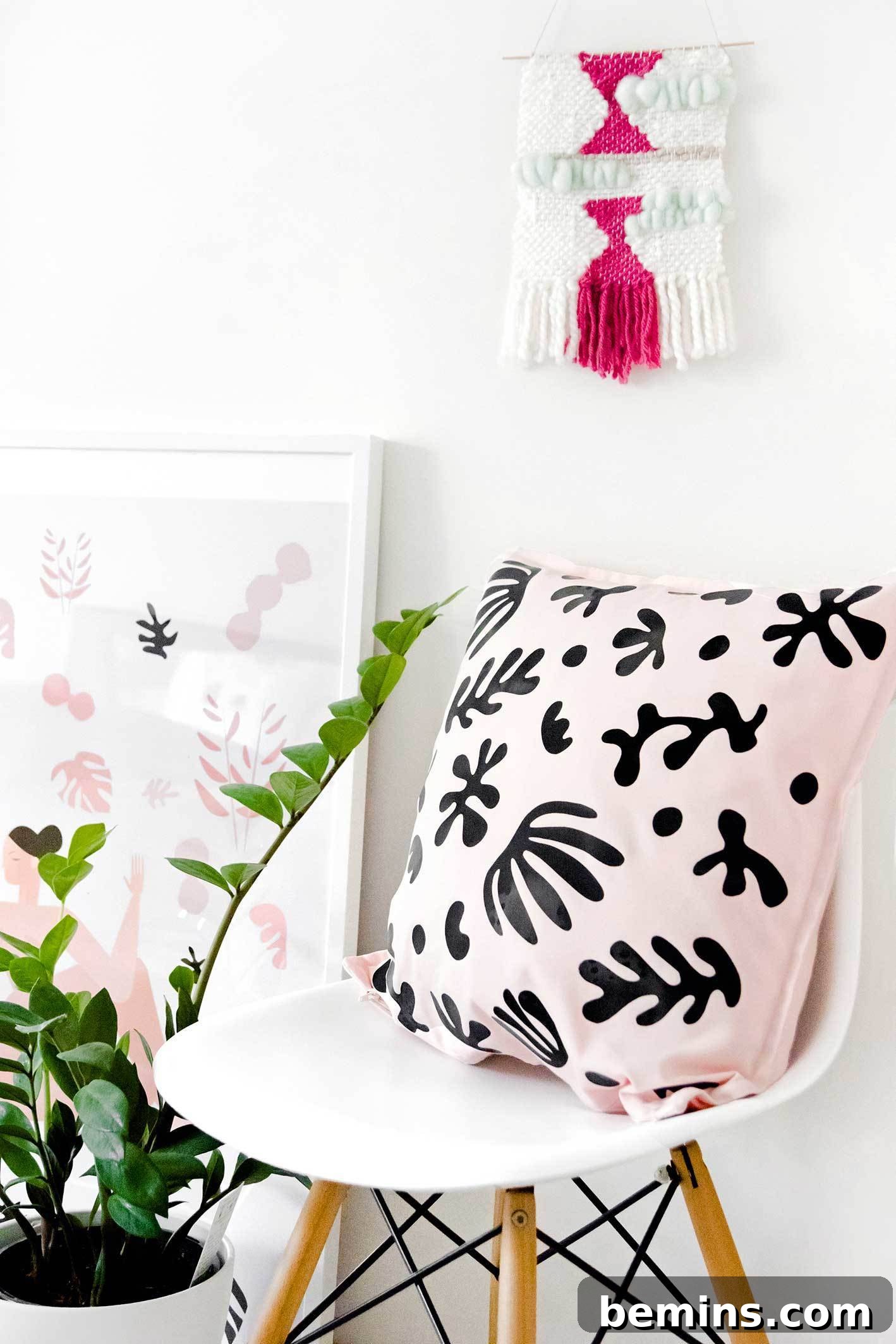 A pink pillow with funky black vinyl decals