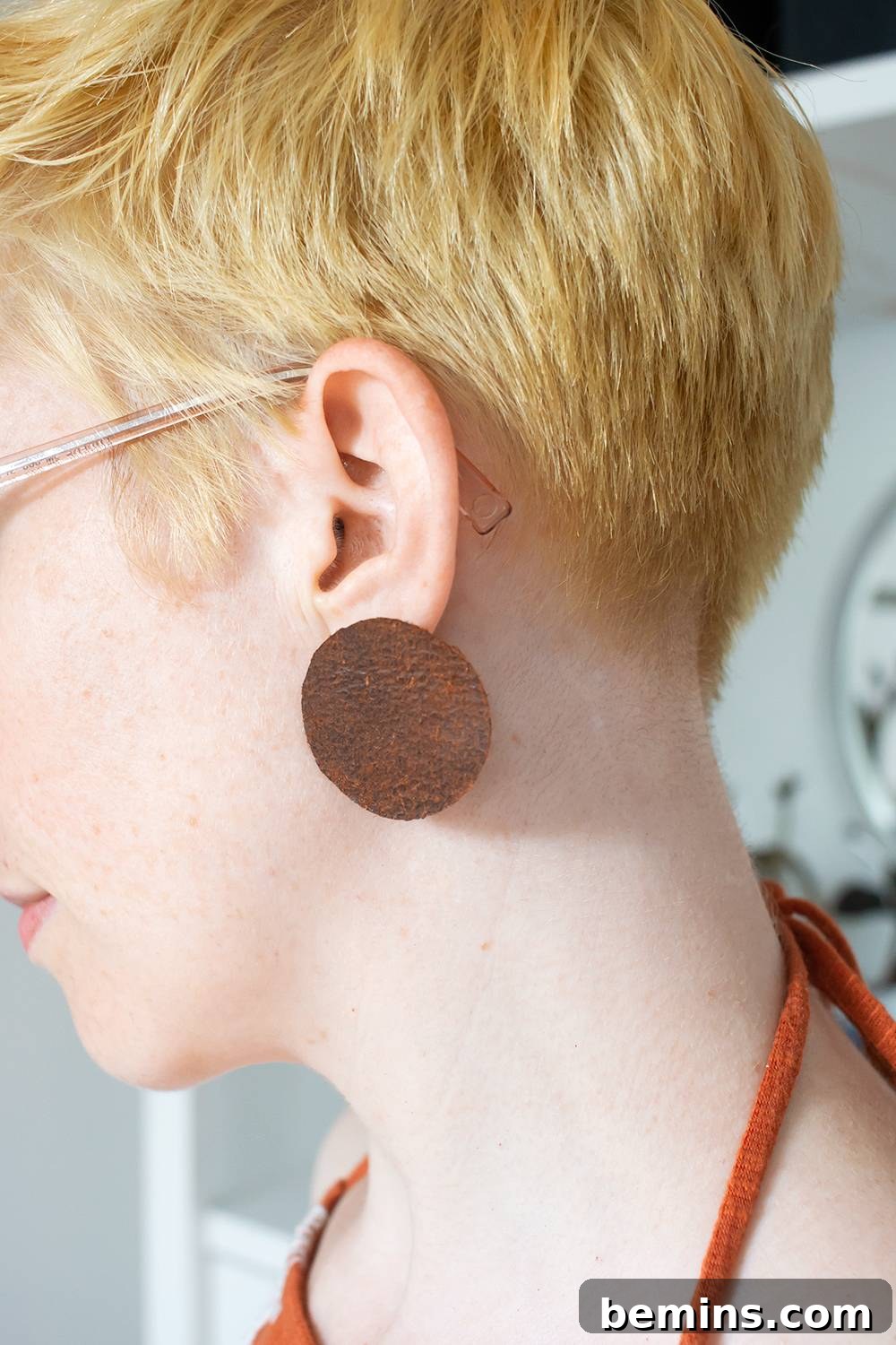 Simple Minimal Leather Earring Project 15 Detail view of handcrafted leather earrings on an ear, showcasing their wearability.