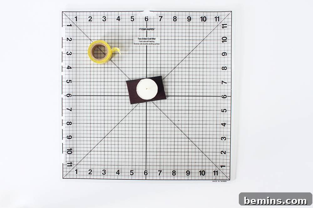 Simple Minimal Leather Earring Project 6 Taping a tea light (round object) onto the leather to serve as a cutting guide.