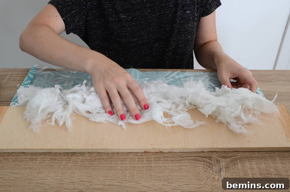Craft Your Pup's Outdoor Oasis 10 Adding stuffing to dog bed side
