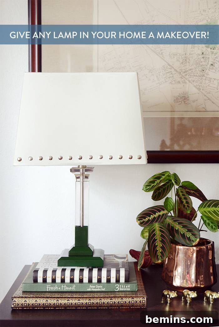 Studded lamp shade with a green base sitting on a stack of books.