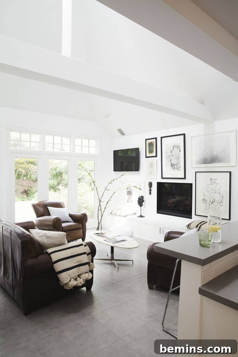White room furnished with chairs and pictures.