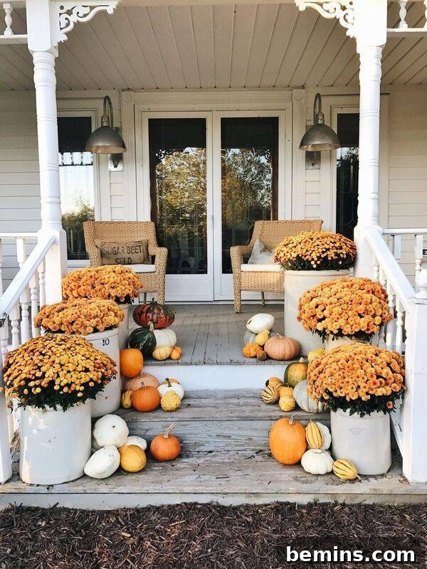 Fall decor extending all the way down front steps, creating a grand and festive entrance