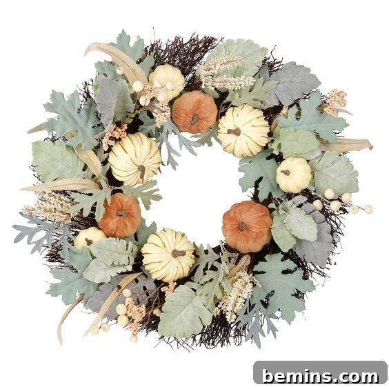 A cream velvet pumpkin wreath from Michaels, eschewing traditional fall colors for an elegant look