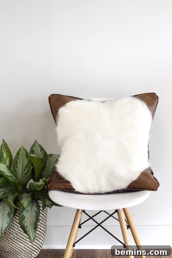 A faux leather and faux fur pillow, adding a touch of texture and warmth to your sofa or armchair