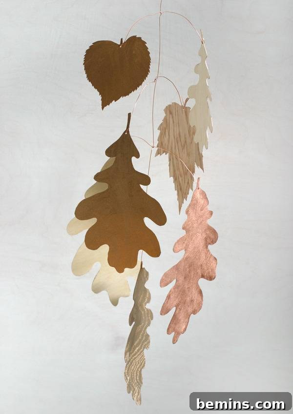 A metallic gilded autumn leaf mobile, adding a touch of whimsy and elegance to your dining space