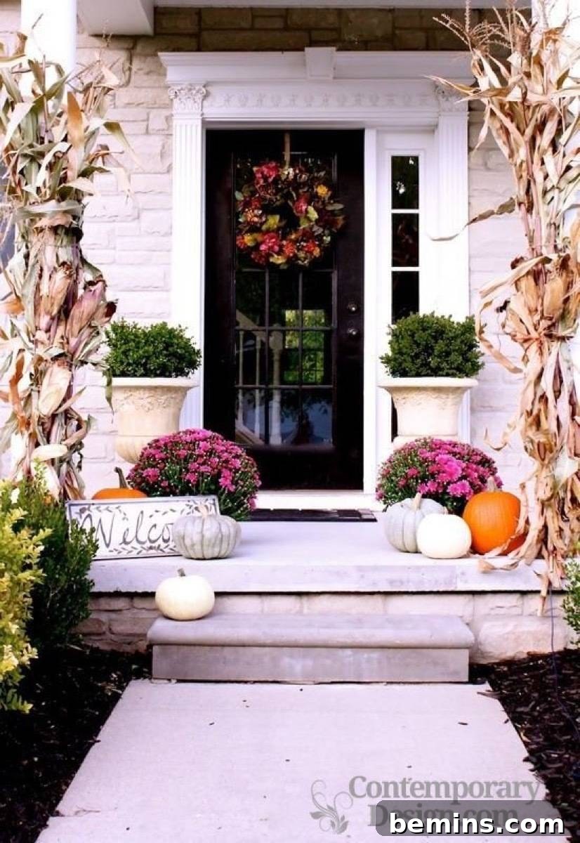 A front porch design incorporating magenta-colored mums, adding an unexpected twist to the traditional fall color palette