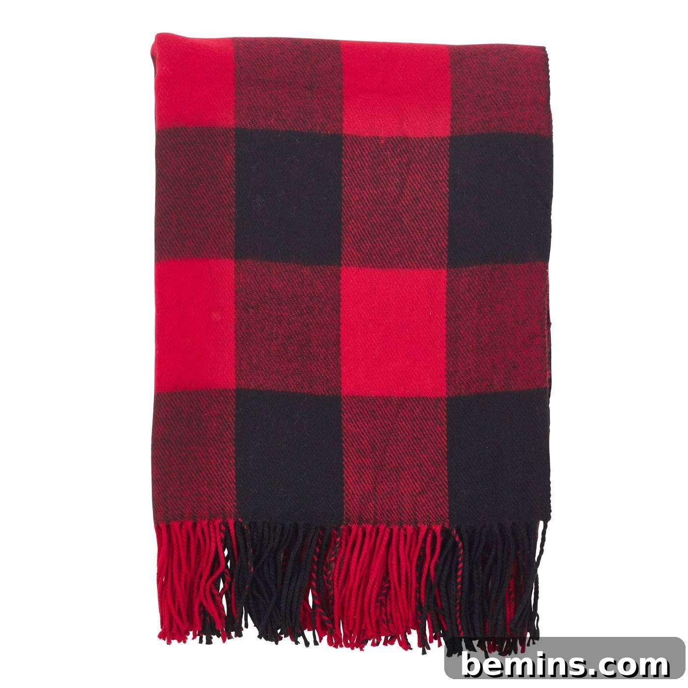 Folded black and red checkered blanket with fringe, adding a cozy touch to any room