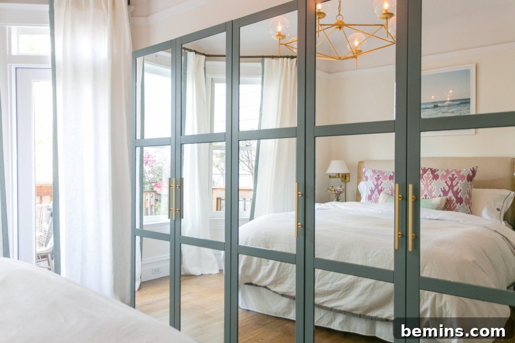 Crafting Your Perfect IKEA Closet: A Design Guide 26 A bed with white bedding is reflected in a wall of mirrors.