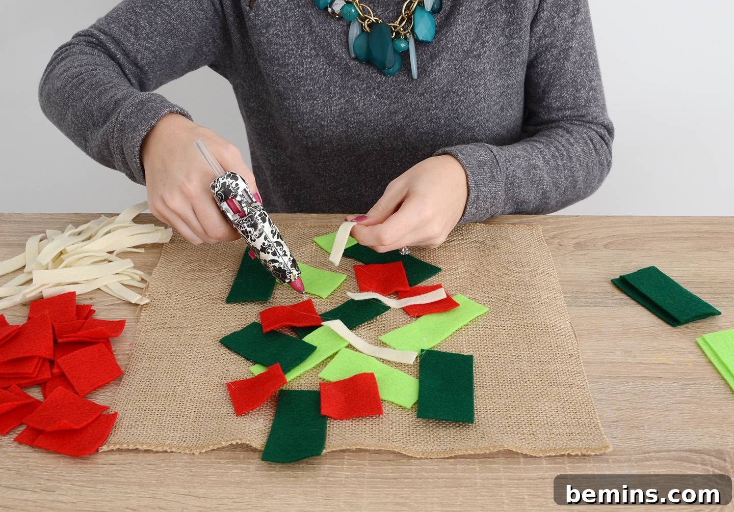 Gluing the felt toppings randomly onto the burlap piece
