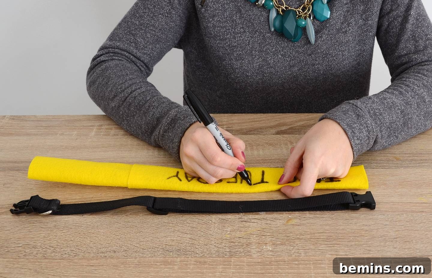 Writing 'Taco Tuesday' on the yellow felt collar cover