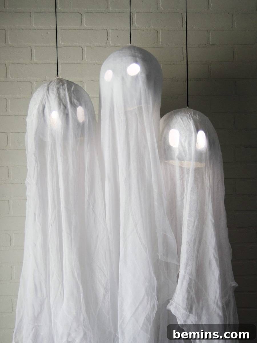Hanging ghosts with suspended glow sticks inside