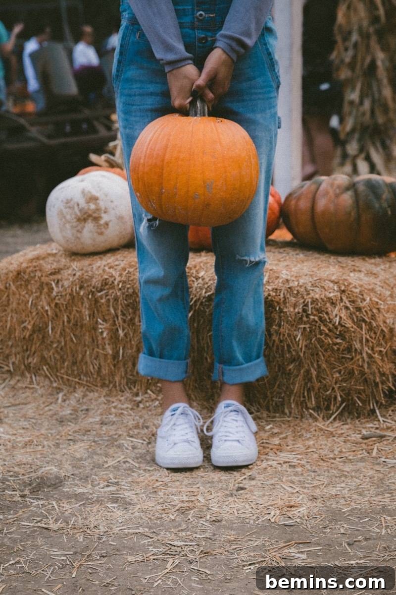 The Ultimate Fall Bucket List 3 Woman holding pumpkin